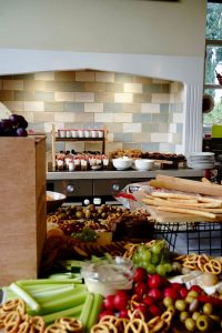 Kitchen iskand laden with party food.